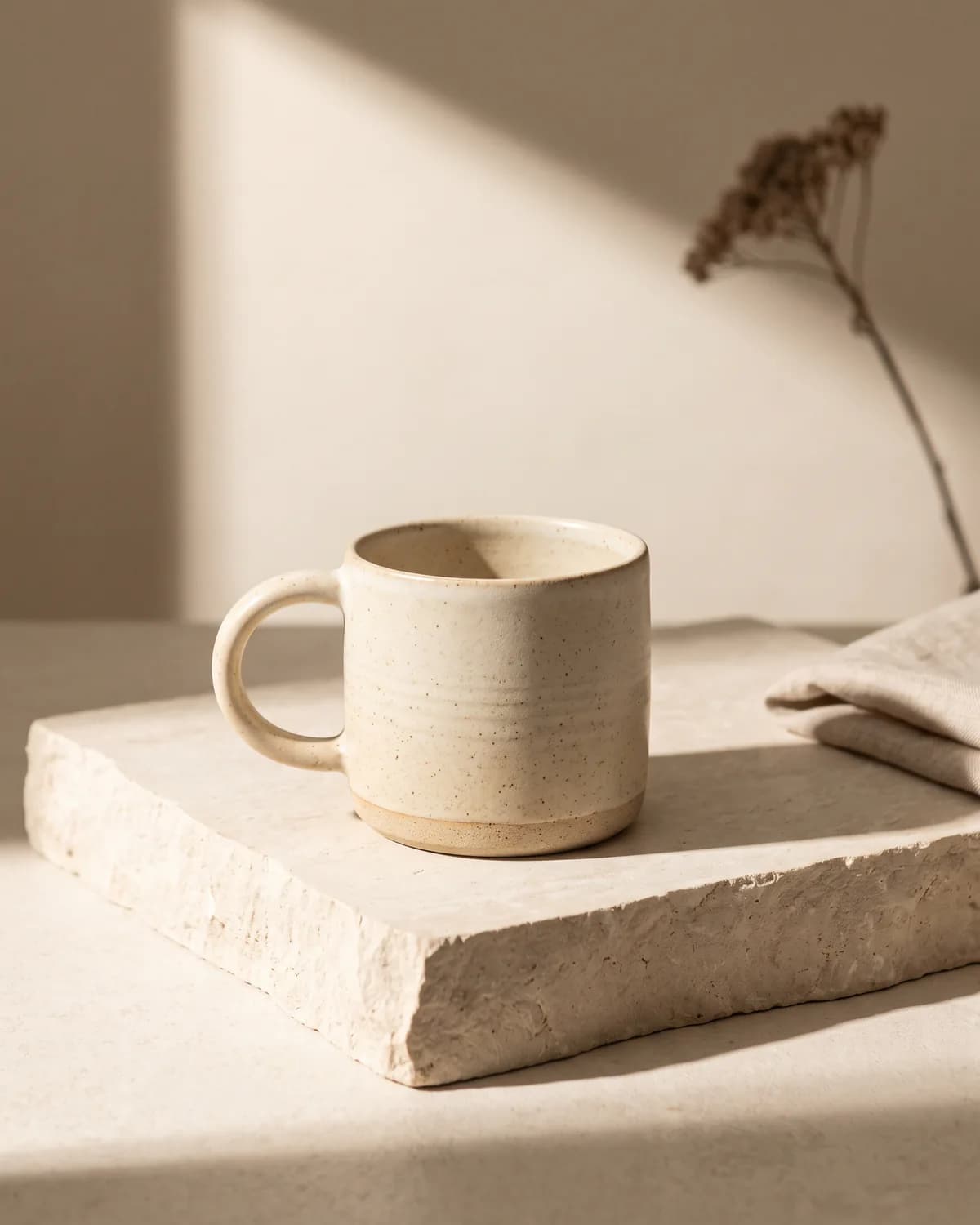 Speckled handmade ceramic mug in natural light