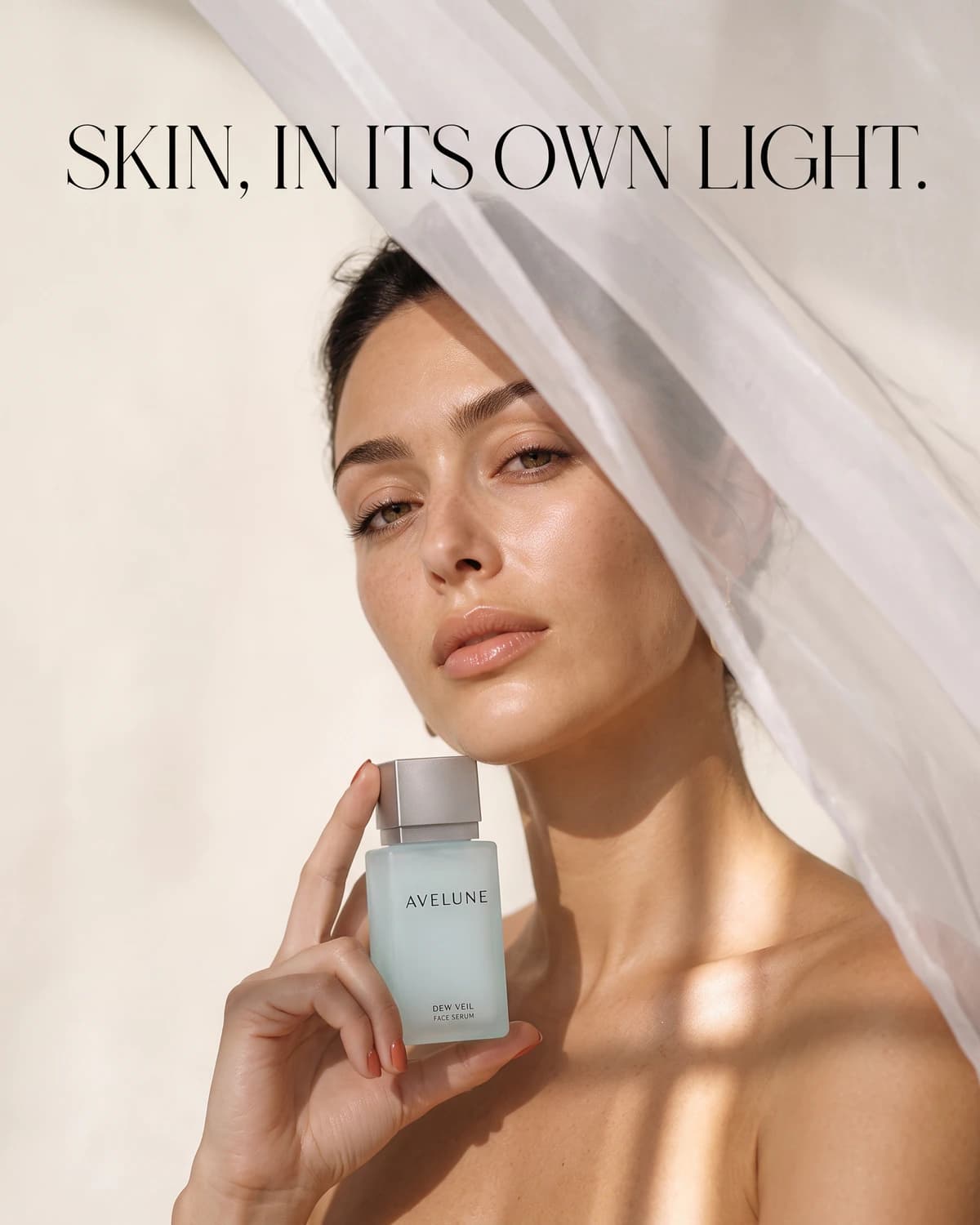 Instagram campaign with an adult model holding AVELUNE serum behind pearl-white fabric